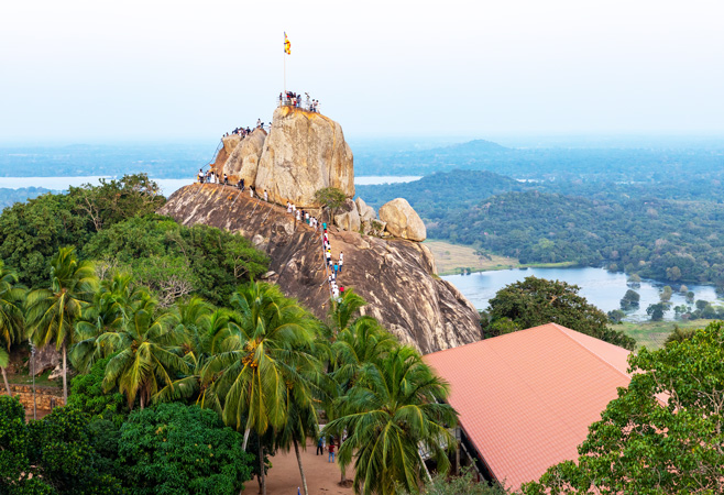 Pilgrims climbing the famous rock steps to Aradhana Gala (Invitation Rock) at Mihintale