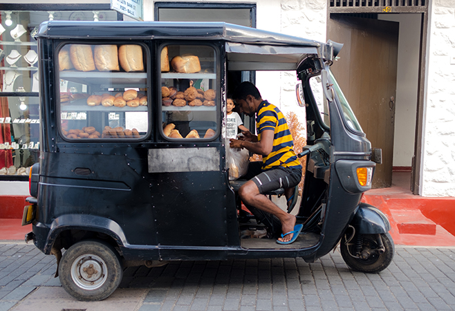 A street vendor preparing freshly made a must-try local delicacy