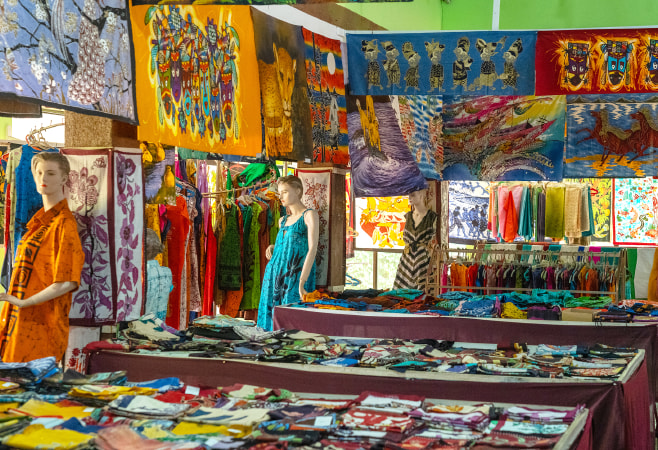 Colorful batik fabrics are displayed in a Sri Lankan market