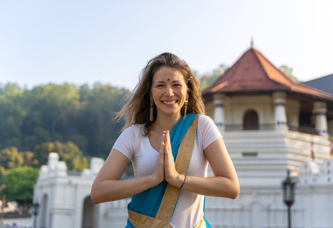 Tourists wearing modest clothing while visiting a temple in Sri Lanka